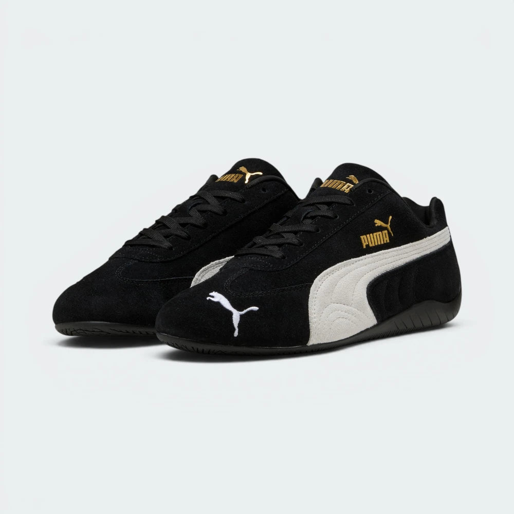Emphasises the low-profile, forward-leaning athletic stance of the trainers, highlighting the classic sport harmony of the black suede and white leather accents.