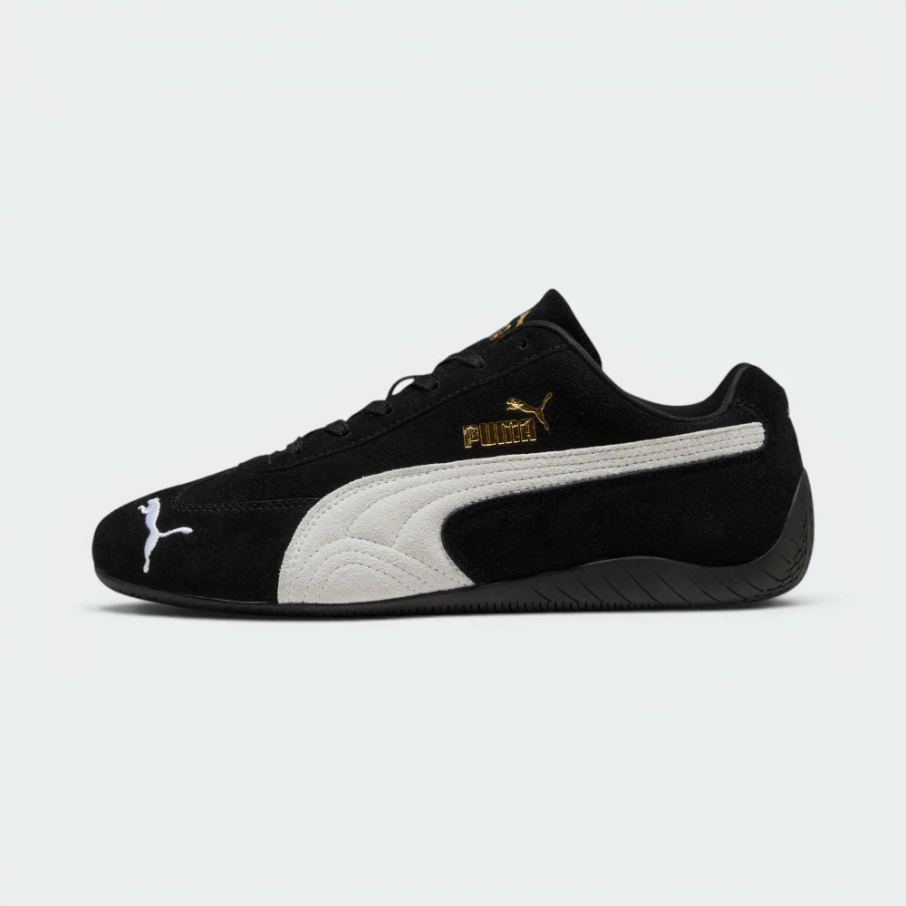 Highlights the "unreal" low-profile interface where the slim black rubber sole meets the suede upper, emphasizing the minimalist motorsport design.