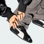 Displays the complete tire-tread tread pattern of the durable black rubber sole, featuring the centered Puma Cat logo engineered for multi-directional grip.