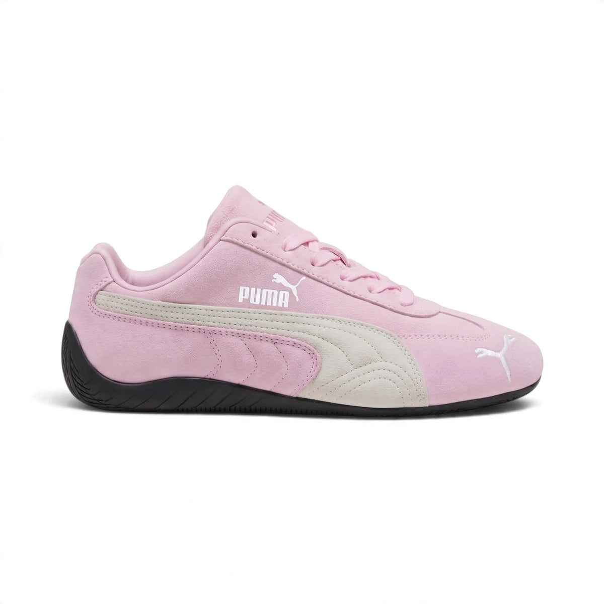 Displays the full lateral silhouette featuring the soft Whisp of Pink suede chassis, contrasting PUMA White suede Formstrip overlay, gold foil PUMA branding, ultra-slim black rubber midsole tape, and wrap-around rounded heel tyre tread.