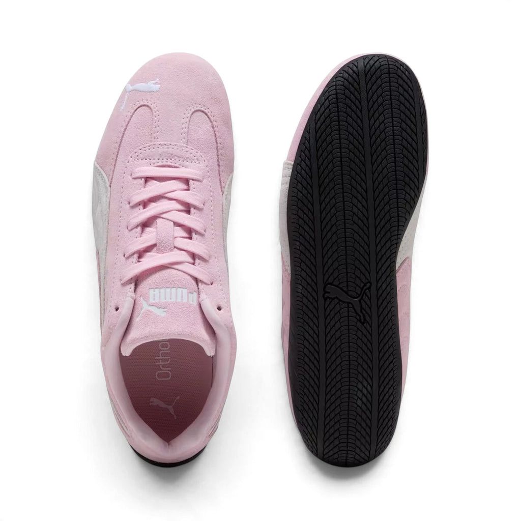 Top-down view of both shoes displaying the symmetric lacing system, padded tongues with PUMA branding, and OrthoLite insoles next to the bottom profile of the rubber tyre outsole.