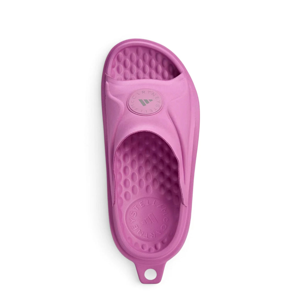 Overhead top-down layout of the slide, displaying the circular textured footbed pattern, brand typography stamped at the heel, and the wide mesh forefoot strap.
