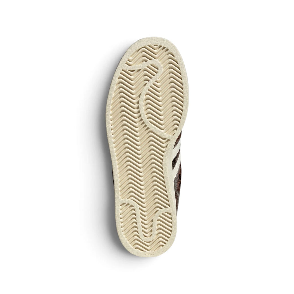 Bottom-down view of the cream rubber outsole, showcasing the heritage herringbone traction pattern and central embossed adidas branding.