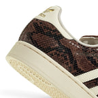 Detailed close-up angle capturing the textured heel stitching, rubber midsole sidewall, and herringbone tread edge.
