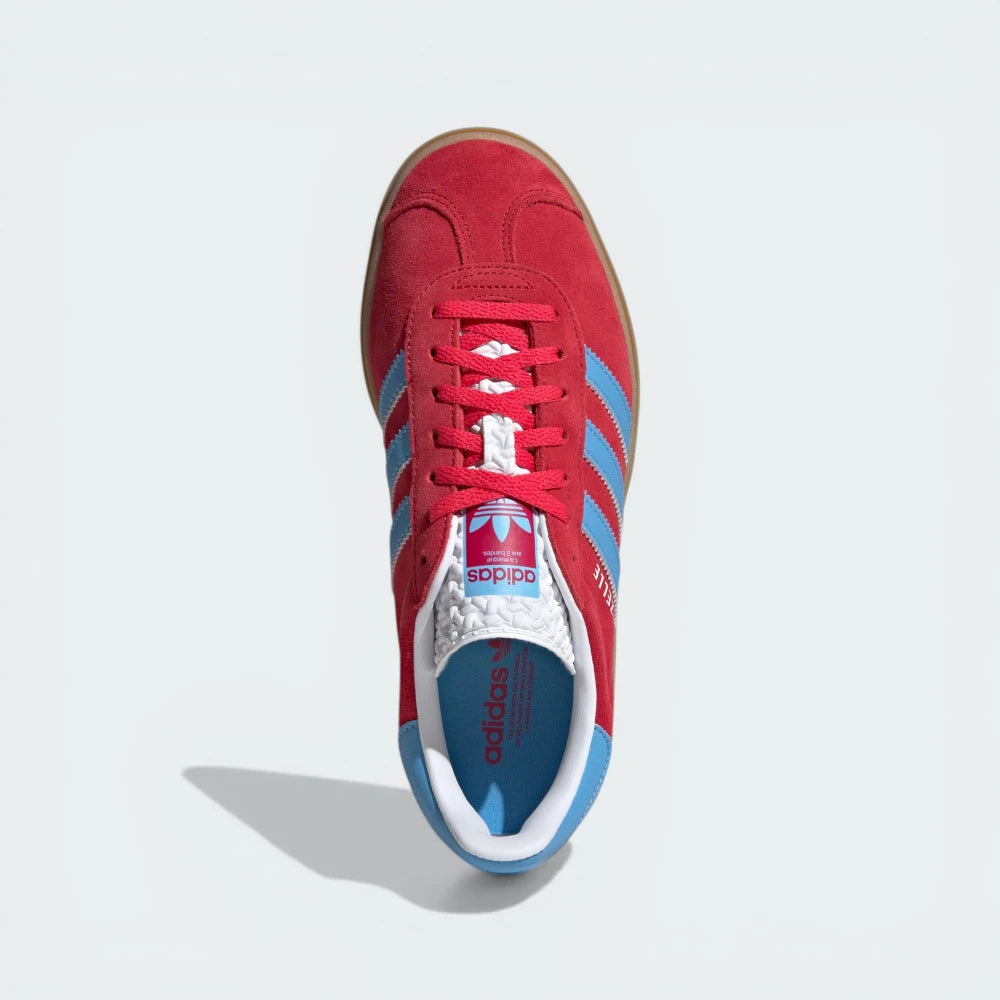 Looking down at the pink suede lacing system and the textured tongue branding.