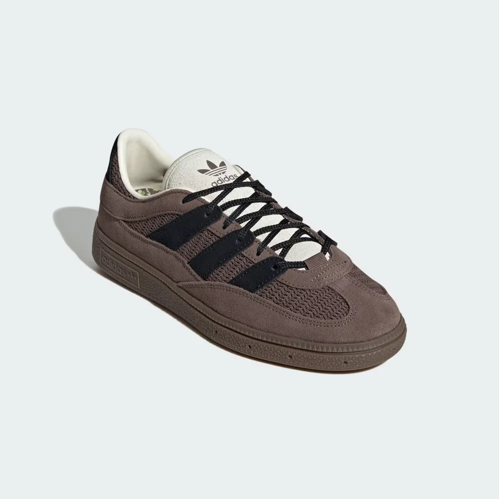 Emphasizing the T-toe overlay and the unique blend of leather and textile materials.