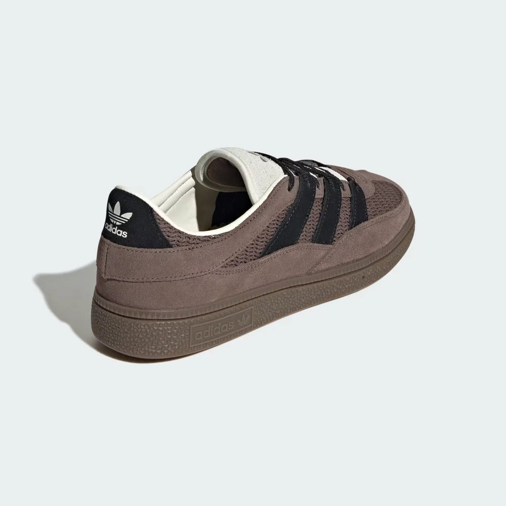 Focusing on the Core Black heel tab and the seamless transition into the gum outsole.
