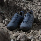 Blue athletic shoes on a rocky surface
