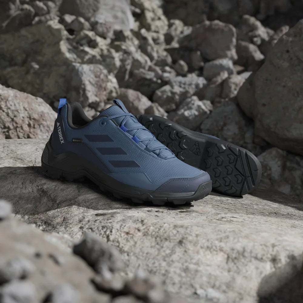 Blue hiking shoes on a rocky surface