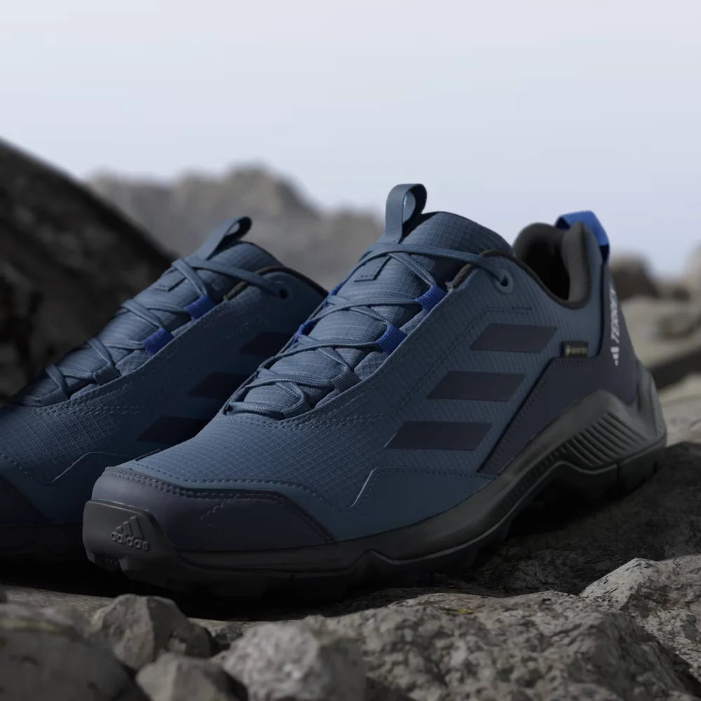 Blue hiking shoes with black accents on a rocky surface