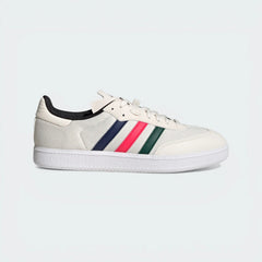 Side Profile Image: The Chalk White Velosamba, highlighting the multicolour 3-Stripes and the recessed cleat area in the white outsole.