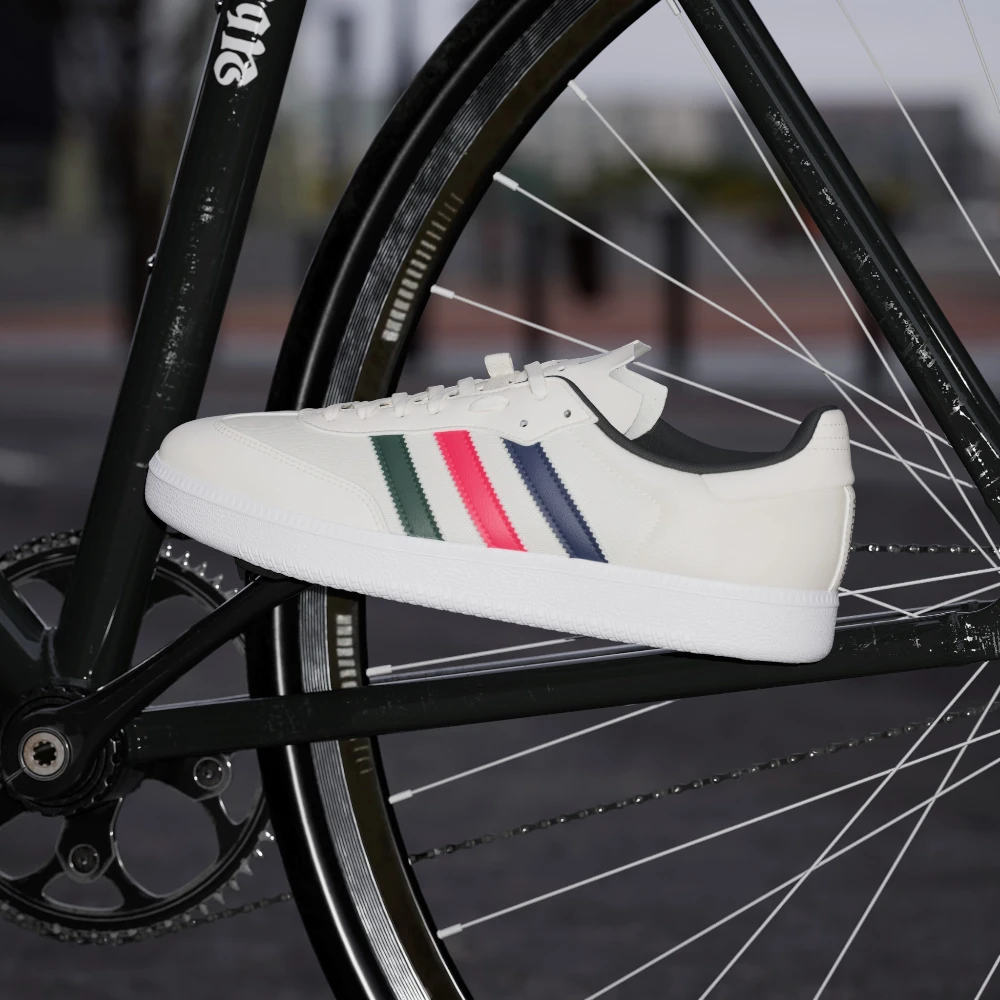 White sneaker with colourful stripes on a bicycle wheel