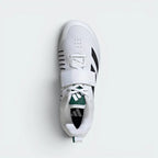 Focuses on the locked-in lace-and-strap combo layout, displaying the perfect symmetry of the white textile tongue, the broad black closure strap, and the distinctively wide, roomy shape of the front toe box matrix.