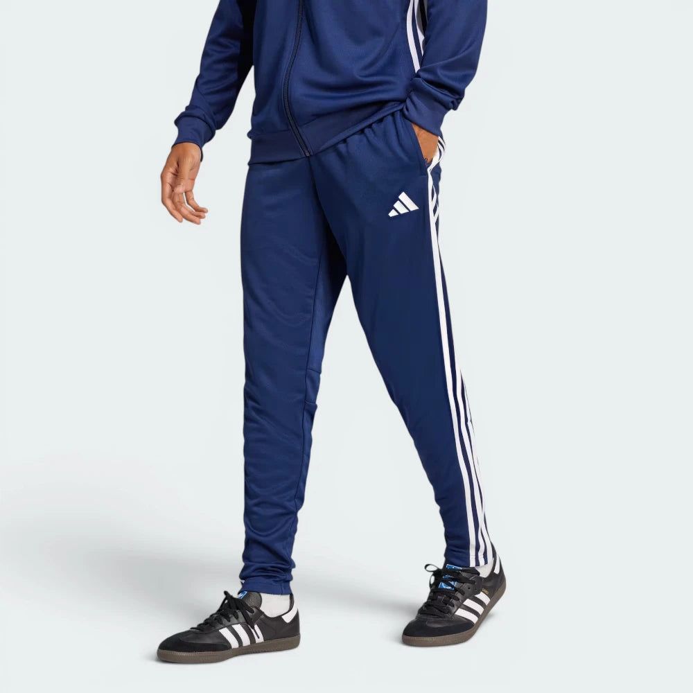Highlights the high-velocity sweep of the continuous white 3-Stripes running flawlessly down the professional, deep athletic depth of the Team Navy Blue 2 leg panels. Main image