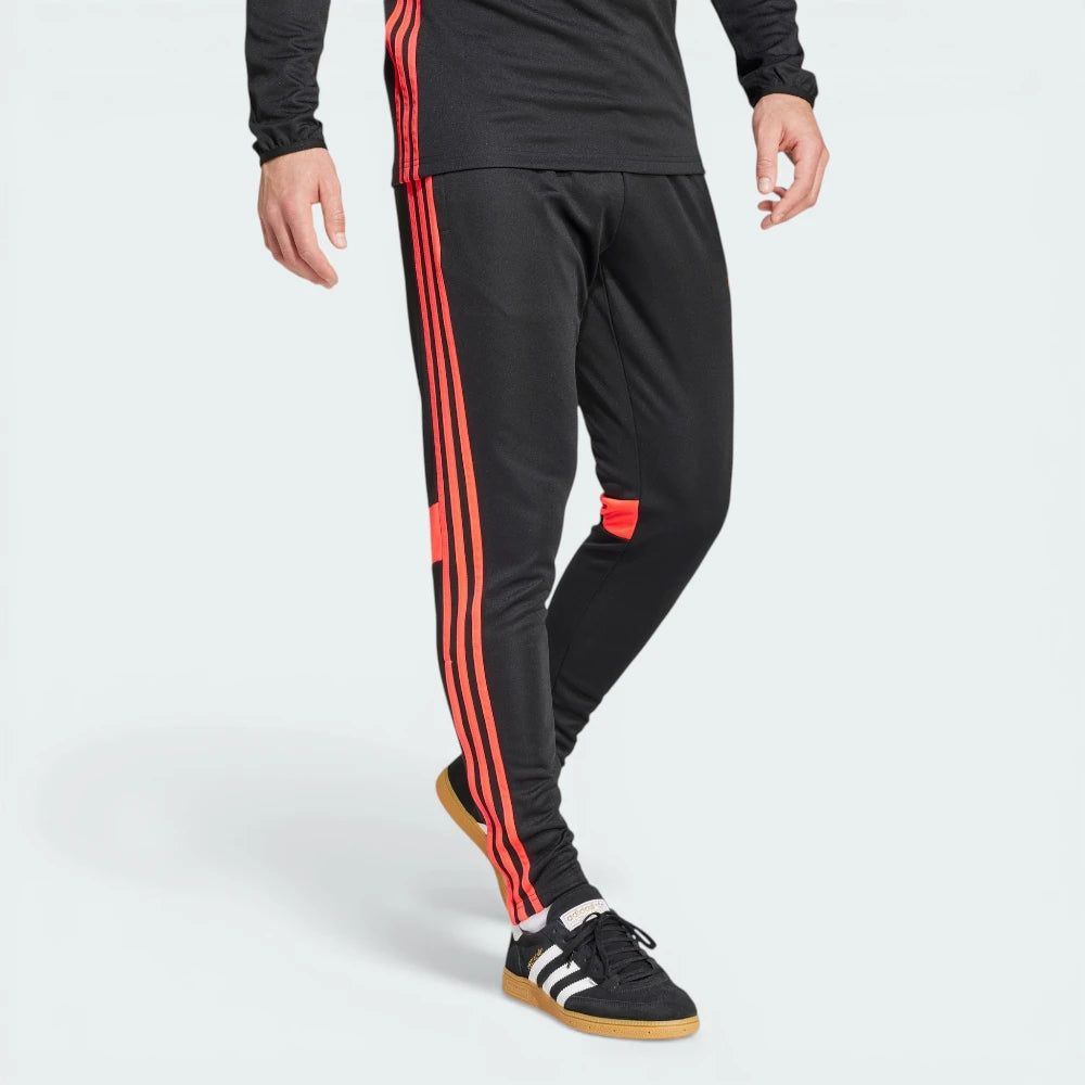 Angle view showing the front-left leg, emphasizing the contrast Adidas logo and the clean pocket construction.