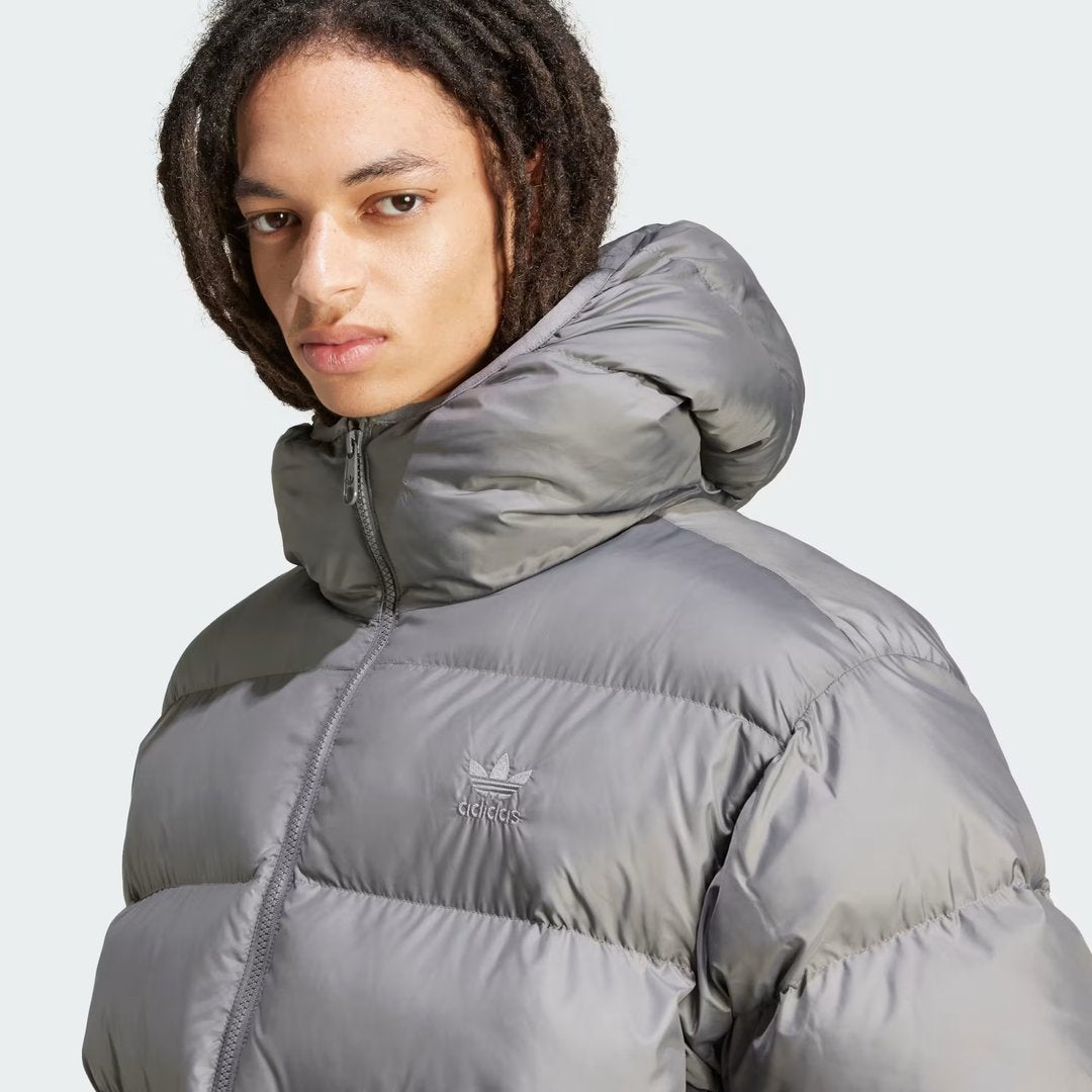 Close-up zoom on the fabric of the Adidas Tonal Hooded Puffer Jacket Men's, showing the quilted puffer texture and subtle Adidas logo.