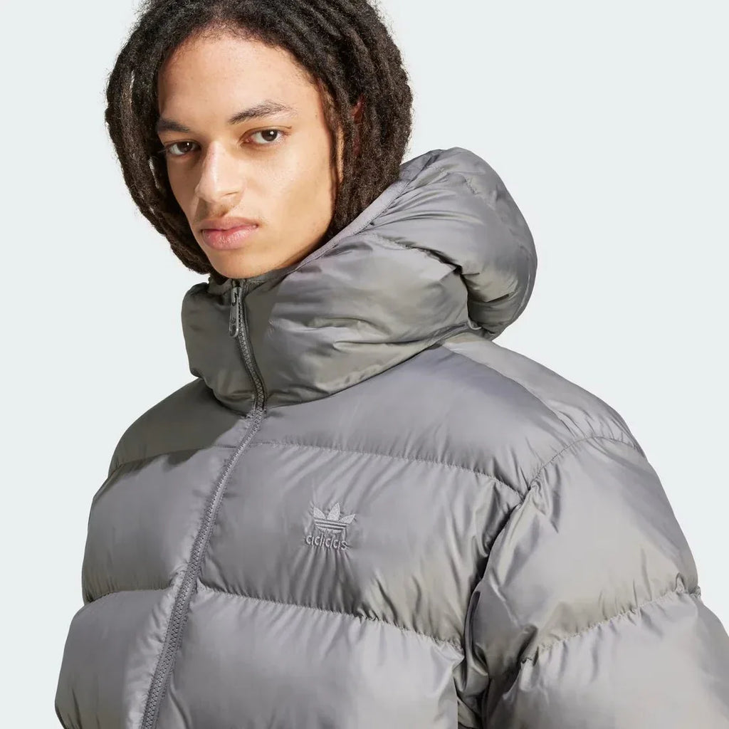 Close-up zoom on the fabric of the Adidas Tonal Hooded Puffer Jacket Men's, showing the quilted puffer texture and subtle Adidas logo.