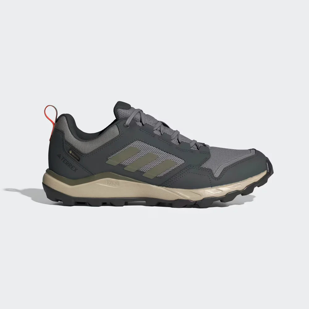 Gray and beige Adidas hiking shoe on a light gray background