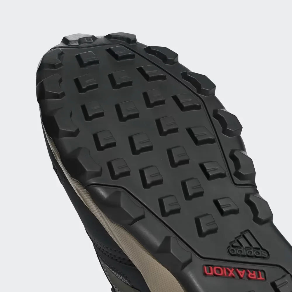 Close-up of an Adidas hiking shoe sole with tread pattern on a white background