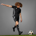 Angle view of the ball on a grass surface, emphasizing the official UEFA Champions League printed logo.