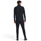 Showcases the rear profile on the model, detailing the clean back yoke seam across the shoulders and the slim tapering down through the calves and ankles.