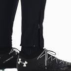 Details the lower leg construction, displaying the open black vertical ankle zip, ribbed cuff seam, and easy transition over black laced football boots.