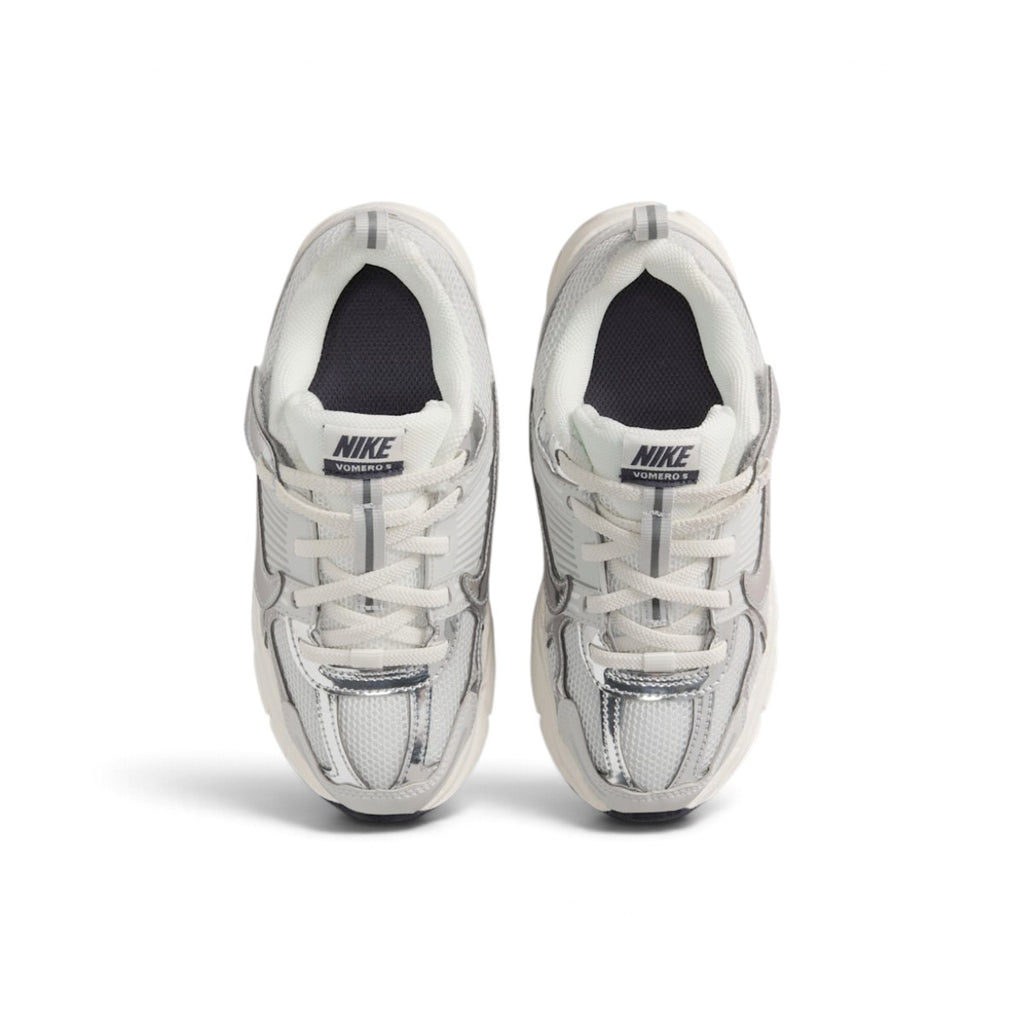Overhead top-down view looking down at the laced children's shoes, displaying elastic laces, tongue branding tags with Vomero 5 text, and cushioned collars.