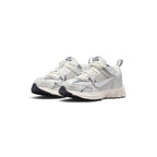 Front three-quarter perspective capturing the rounded toe box, metallic chrome overlays, and breathable forefoot mesh.
