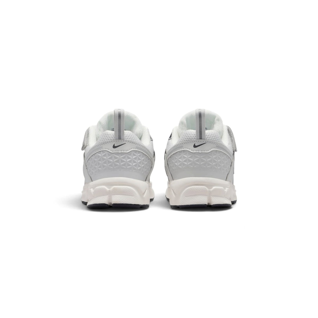 Rear-facing perspective focusing on the geometric molded heel counters, vertical pull tabs, and curved base of the foam midsole.