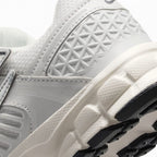 Detailed close-up angle focusing on the geometric molded heel pattern and textured midsole sidewall.