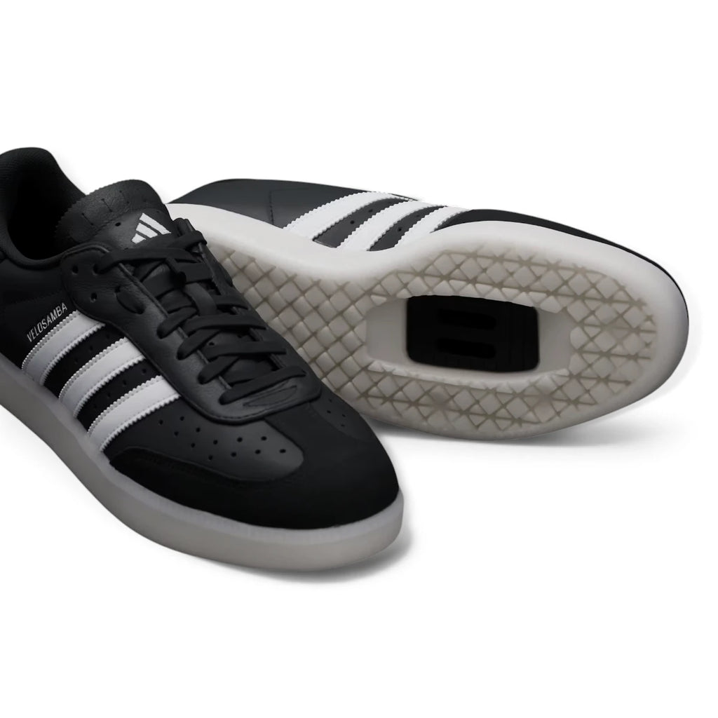 Outsole View: Bottom-down view of the synthetic outsole, showcasing the recessed two-bolt cleat mounting plate and the patterned grip tread designed for traction on and off the bike.   