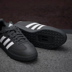 Details the premium dual-stitching lines tracing the iconic T-toe reinforcement textile panels and the precision layout of the lace eyes.