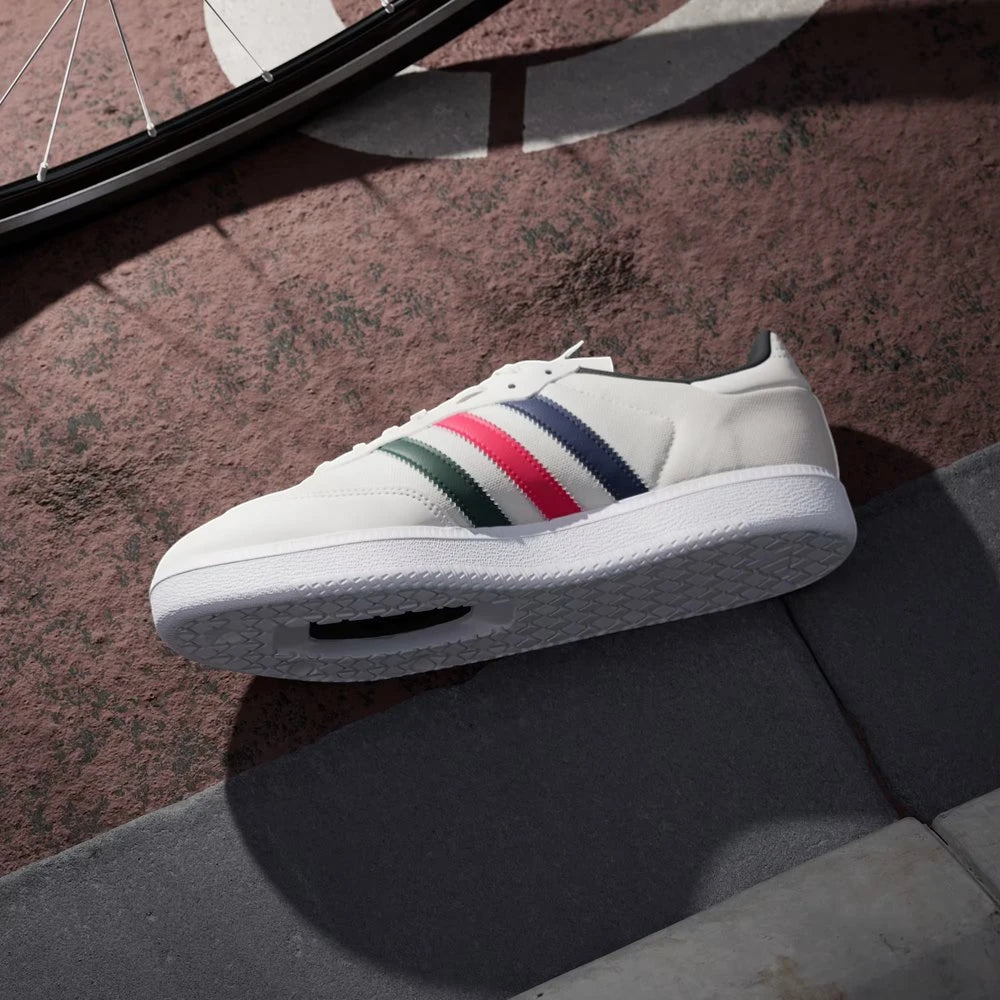White sneaker with colorful stripes on a textured surface