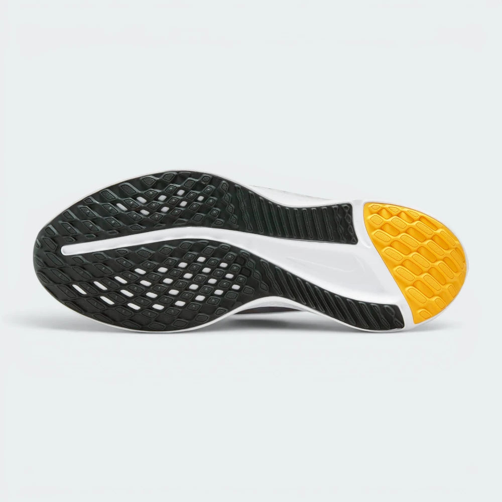 Displays the waffle-inspired tread pattern of the durable dark rubber sole, showing the flex grooves engineered for unreal road flexibility and grip.