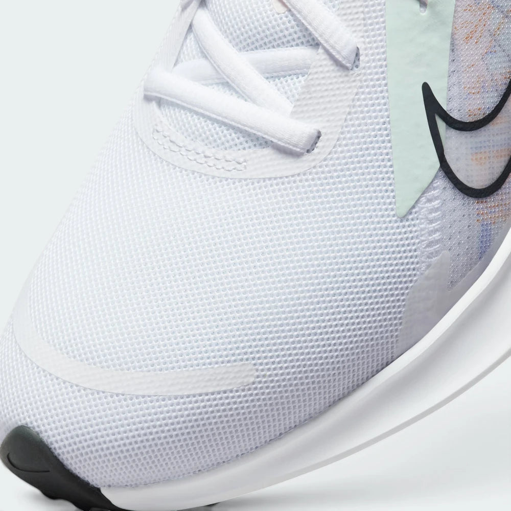 Details the premium precision of the seamless overlays reinforcing the front toe box to defend against debris, alongside the neat tracking of the white laces.