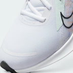 Details the premium precision of the seamless overlays reinforcing the front toe box to defend against debris, alongside the neat tracking of the white laces.
