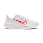 Highlights the lateral profile featuring a bold Bright Crimson Swoosh outlined in orange sweeping across the white mesh upper, Washed Coral midsole rim accent stamped with "ComfiRide", white foam midsole carrier, and a Washed Coral rubber outsole.