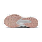 Displays the full-length Washed Coral rubber outsole, showcasing the waffle-inspired road-gripping tread pod pattern, outer flex grooves, and central white stability channel with Nike Swoosh branding.