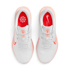 Focuses on the locked-in central lacing layout, displaying the white mesh tongues, matching laces, Washed Coral tongue tabs, and bright crimson insoles printed with white Sunburst pinwheel and "just do it" graphics.
