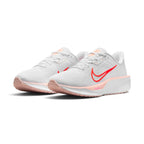 Emphasising the low-cut, athletic stance of the road runners and the clean color contrast between the crisp white uppers, Washed Coral midsoles, and popping Bright Crimson Swooshes.