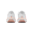 Focuses on the rear profile, highlighting the structured white mesh heel counters with vertical Bright Crimson micro-Swoosh accents, Washed Coral upper rim, and the wide footprint of the white foam midsole base.