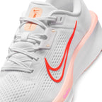 Details the micro-precision of the forefoot mesh upper, showing the white laces, Washed Coral tongue pull tab, synthetic lace stays, and double-layered Bright Crimson lateral Swoosh.
