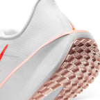 Highlights the "unreal" clean finish where the thick white foam midsole meets the Washed Coral rubber outsole tread, displaying the textured tread lugs and rear heel cup trim.