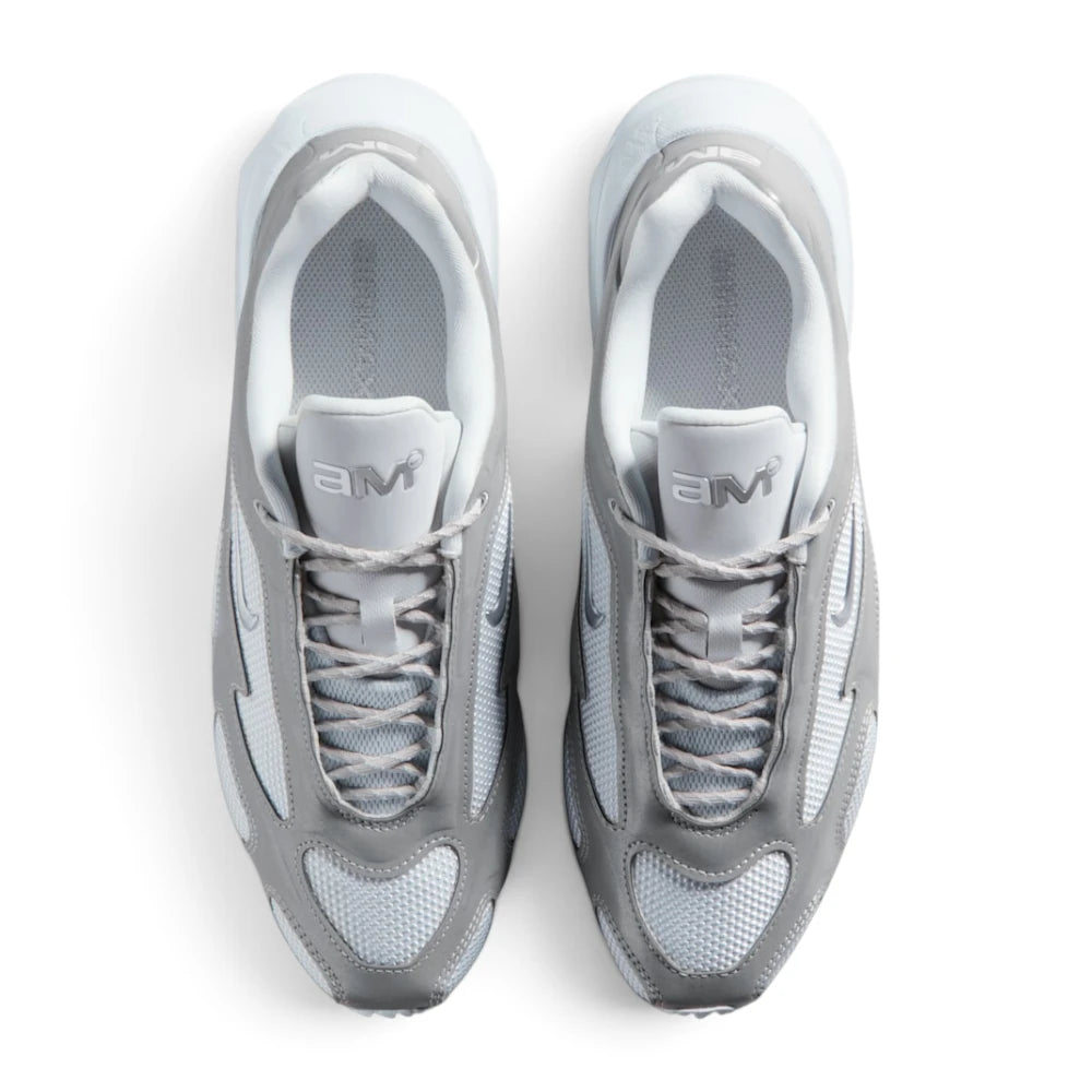 Focuses on the locked-in central lacing layout, displaying grey flecked laces, silver eyestay cages, Pure Platinum mesh toe boxes, and metallic silver tongue badges printed with the modern "aM" Air Max logo.