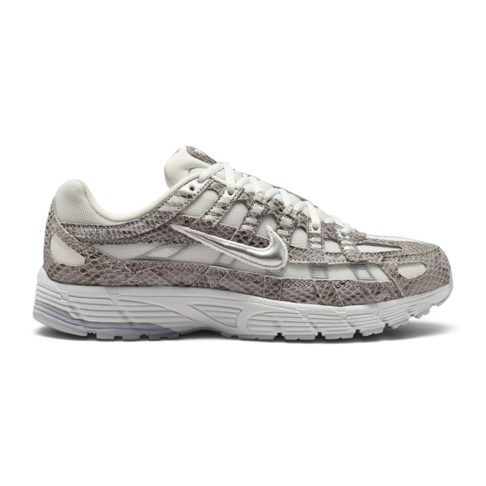 Lateral view showing the breathable off-white mesh upper, textured snakeskin-print suede and leather horizontal ribbing, gleaming Metallic Silver Swoosh outline, lifted sculpted foam midsole sidewalls, and durable black rubber outsole pods. Main image