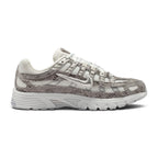 A Nike running shoe featuring a textured snakeskin pattern in shades of gray and white, with a metallic silver Swoosh on the side and a chunky white midsole.