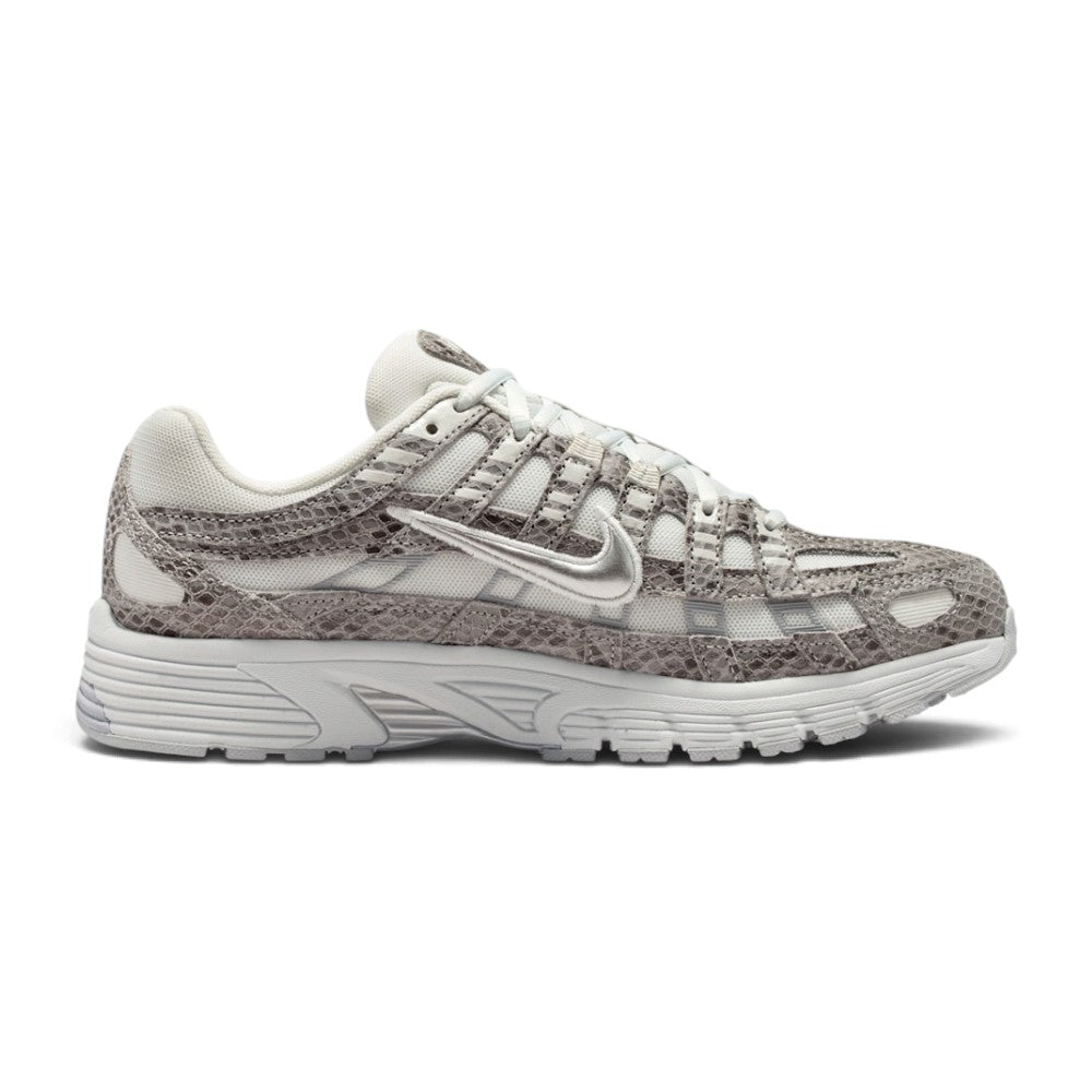 A Nike running shoe featuring a textured snakeskin pattern in shades of gray and white, with a metallic silver Swoosh on the side and a chunky white midsole.