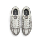 Direct overhead view of the shoe, displaying the airy open-mesh toe box, snakeskin-textured forefoot bumper, central lacing throat with flat off-white laces, padded mesh tongue with branded P-6000 webbing badge, and cushioned sockliner.