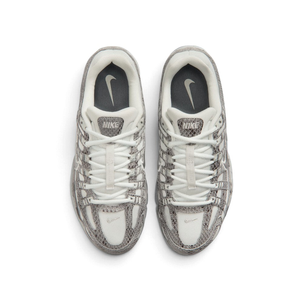 Direct overhead view of the shoe, displaying the airy open-mesh toe box, snakeskin-textured forefoot bumper, central lacing throat with flat off-white laces, padded mesh tongue with branded P-6000 webbing badge, and cushioned sockliner.