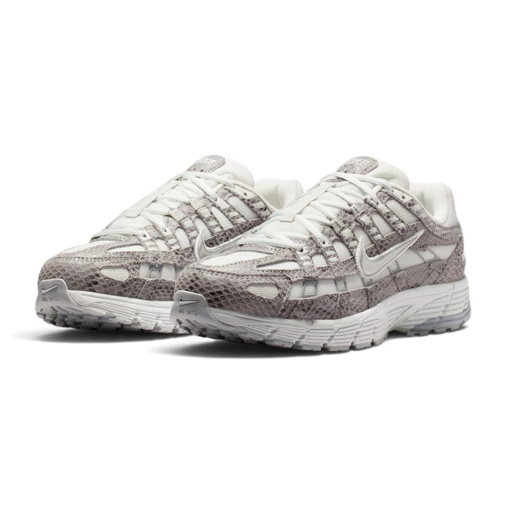 Forward three-quarter angle showcasing both shoes side by side, highlighting the aggressive millennium tech-runner stance, exotic snakeskin texture contrasts, liquid silver accents, and lifted athletic profile.